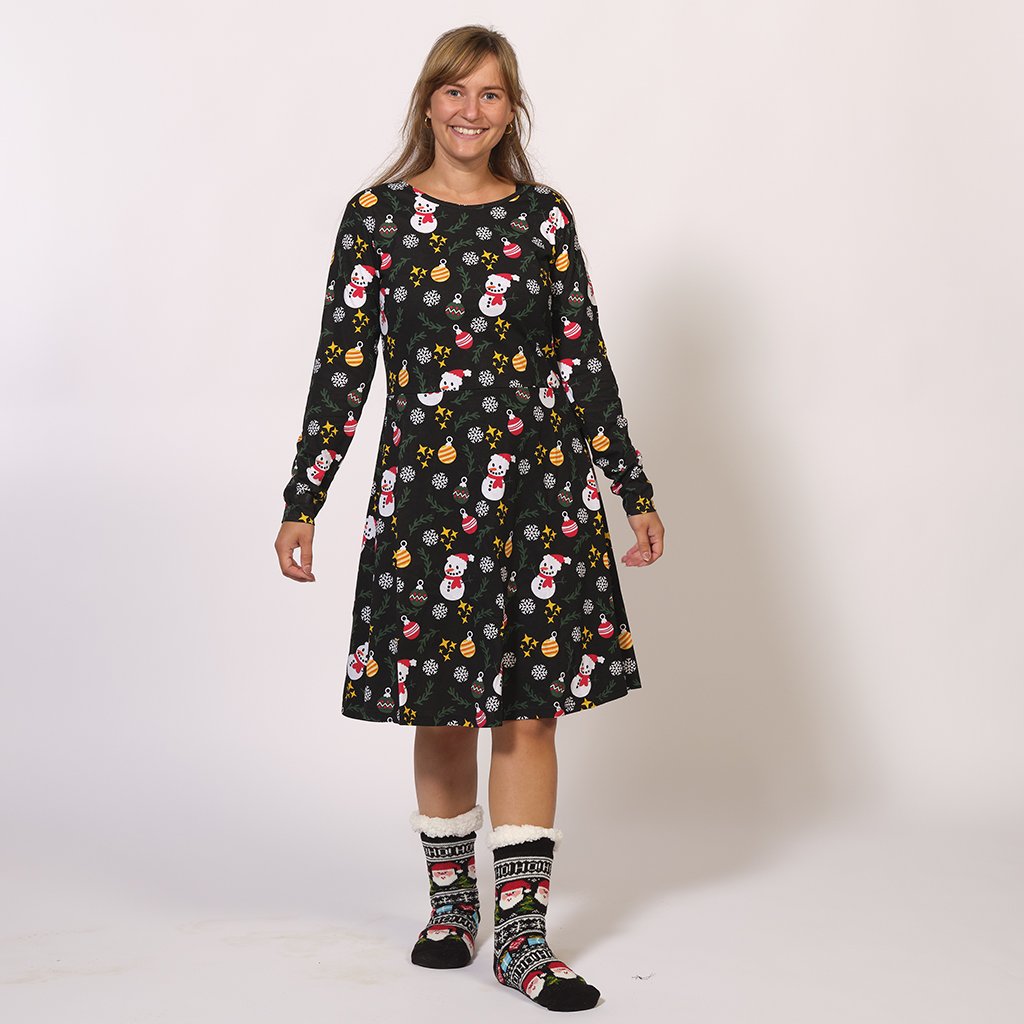 Una donna che indossa un abito natalizio nero.