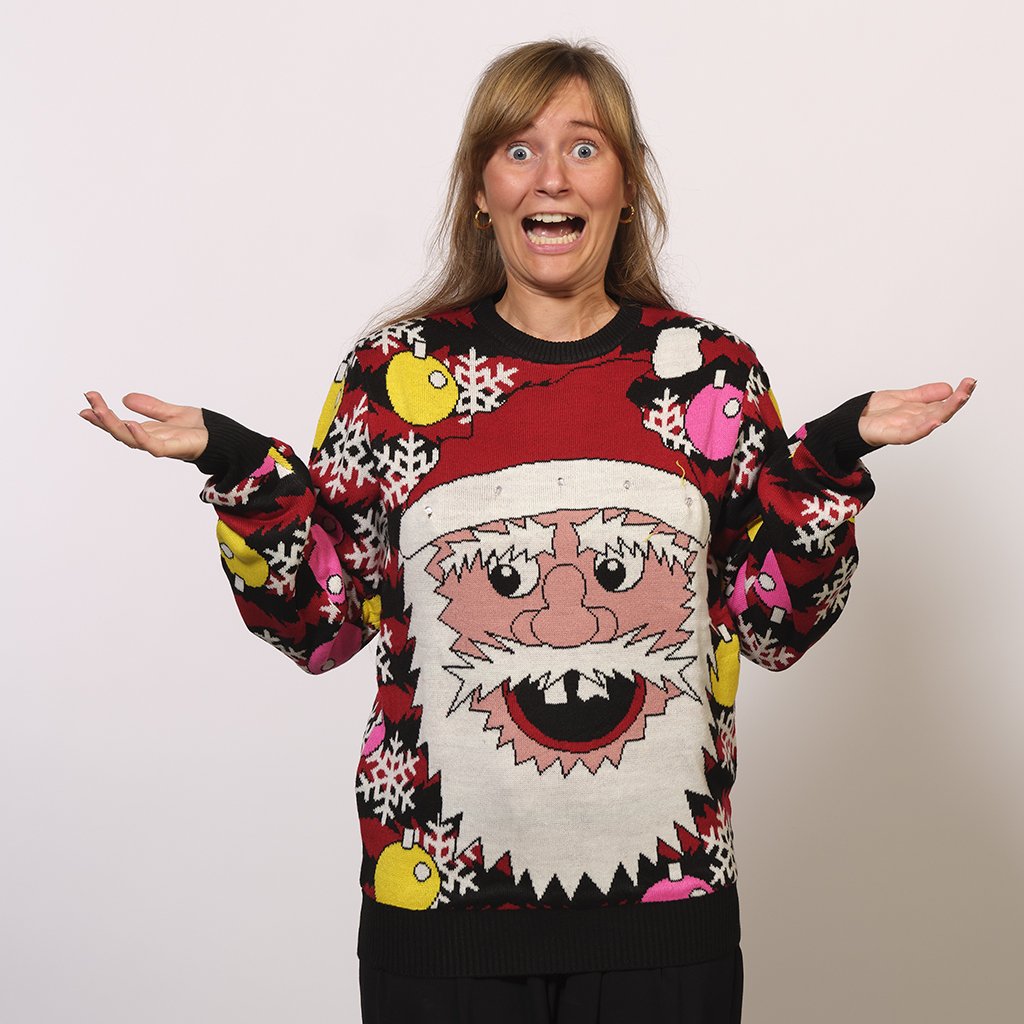 Una donna che indossa un maglione natalizio rosso e nero con un Babbo Natale.
