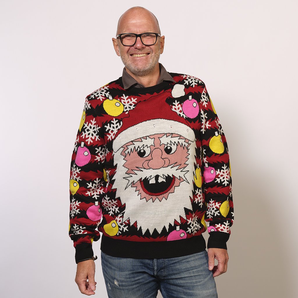 Un uomo che indossa un maglione di Natale rosso e nero con un Babbo Natale.