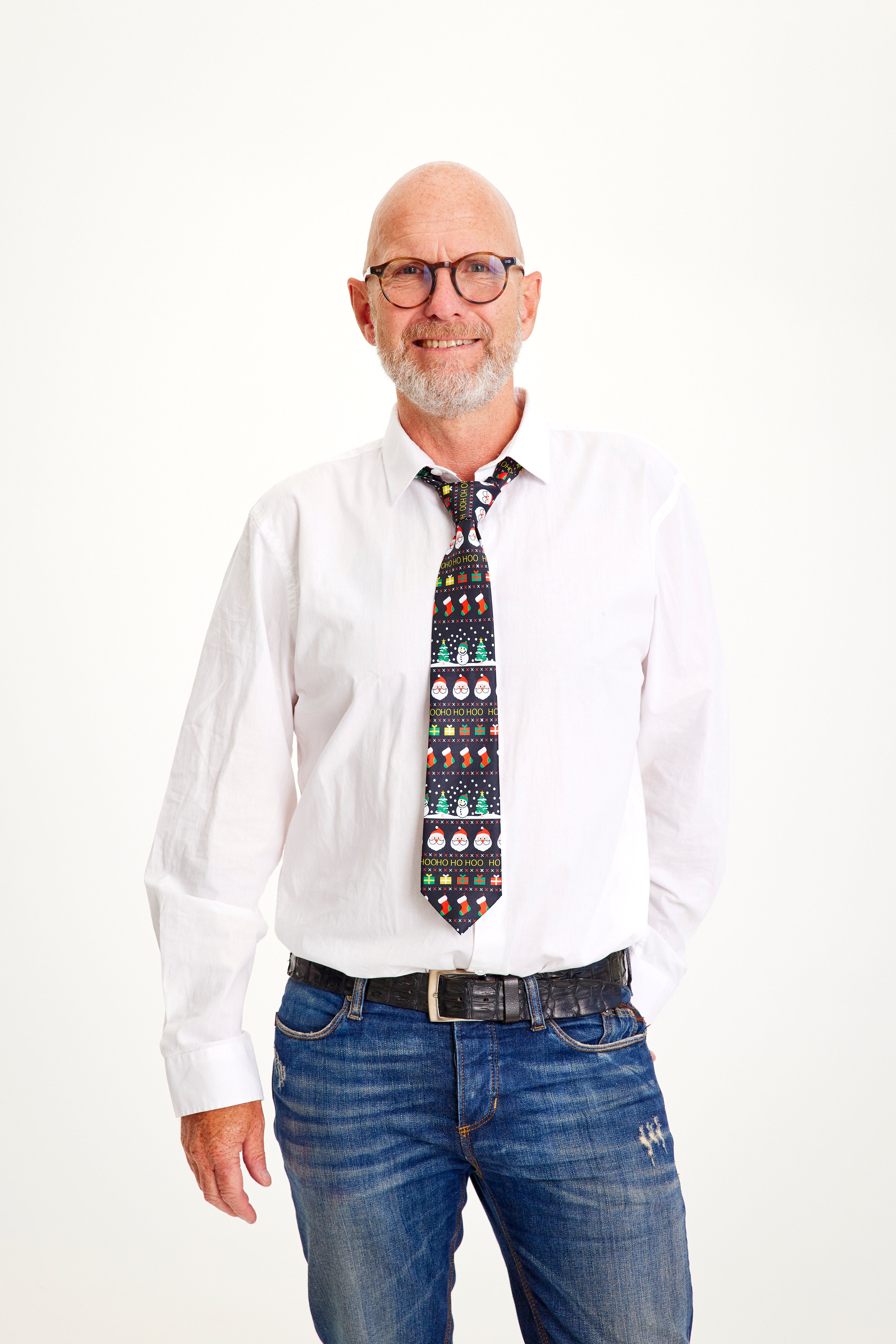 Un uomo in camicia bianca e cravatta natalizia.